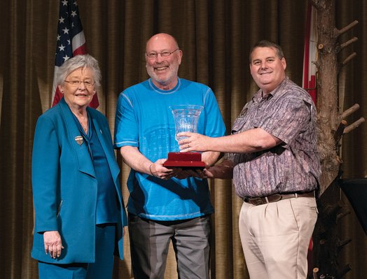 Conservation Advisory Board Chairman Joe Dobbs is presented with the third-place trophy by Governor Kay Ivey and Conservation Commissioner Chris Blankenship.