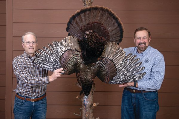 Rob Keck, right, and landowner/guide Ed McCurdy show off the gobbler that finished second in the competition.