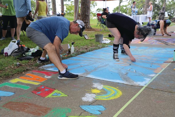 Artists kneeled, bent, even laid down over their sidewalk square to find the perfect angle to create their masterpiece at the Chalk the Trail event Saturday in Fairhope.