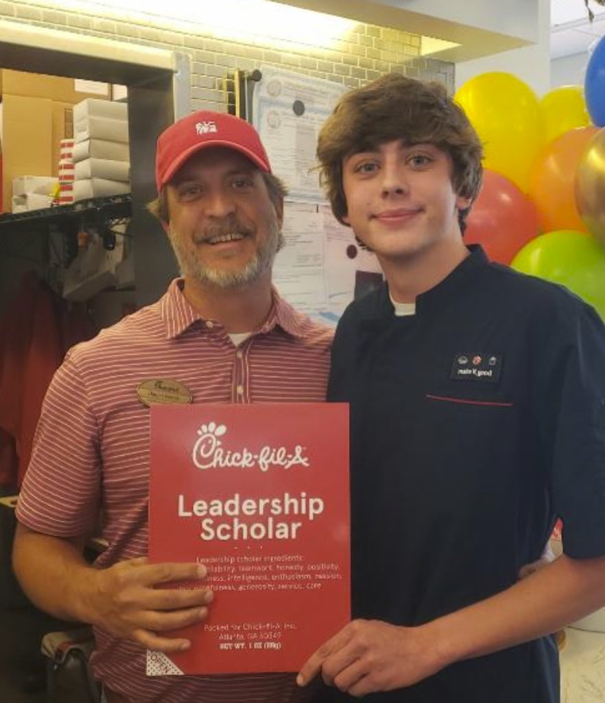 Daniel Nance, operator of Chick-fil-A Daphne with Daphne High School senior Ricky Parker. Parker was recently awarded a scholarship from the restaurant company.