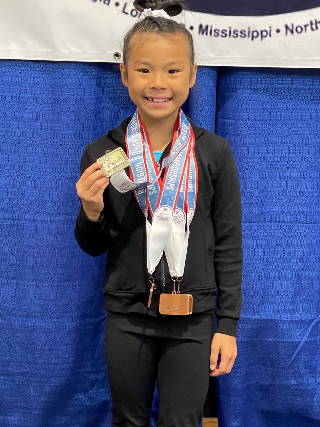 Rosie Roberds, age 8 of Fairhope trains at Eastern Shore Gymnastics Academy. She took home the gold for her floor routine and bronze medal on the balance beam as Xcel Platinum.