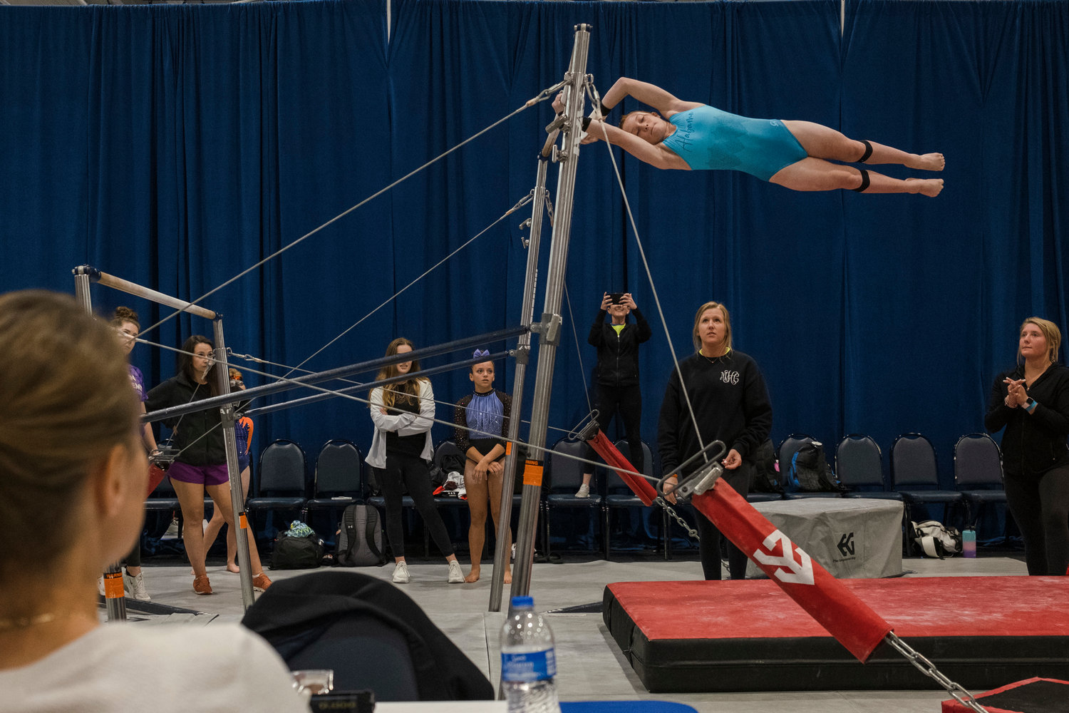 Eastern Shore Gymnastics Academy gymnast Luci LeCroy performs the final skill of her uneven bars routine at the USA Gymnastics Region 8 Xcel Championship in Foley May 6.