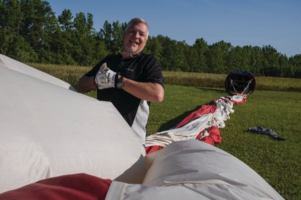 Rusty Miller begins to pack up his hot air balloon, “Stars & Stripes”, in a landing area following a flight outside of Atmore last week.