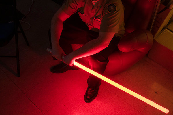 A student in Scott Prince’s class holds a light saber while watching an instructional video.
