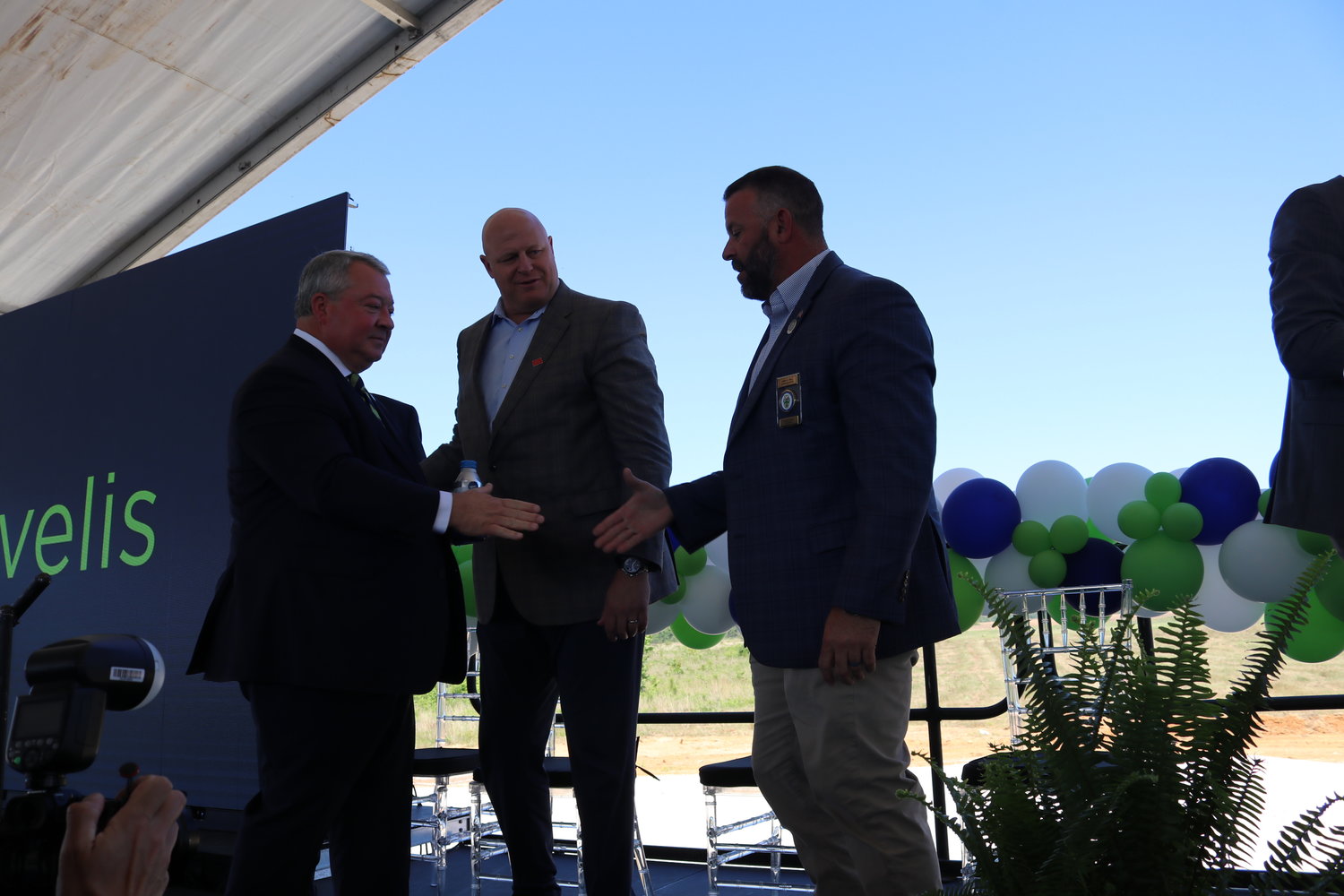 Alabama Secretary of Commerce Greg Canfield, left, congratulates Baldwin County Commission Chairman Jeb Ball following the announcement that Novelis will build a $2.5-billlion plant in Bay Minette. Also pictured is Tom Boney, Novelis North America president.