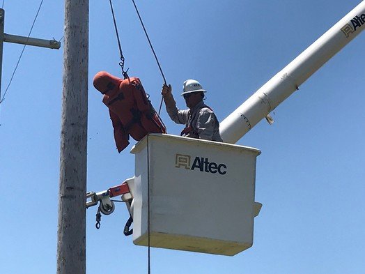 A Riviera Utilities employee practices rescuing someone incapacitated while working on a bucket truck. The training program takes place each year in Daphne and Foley.
