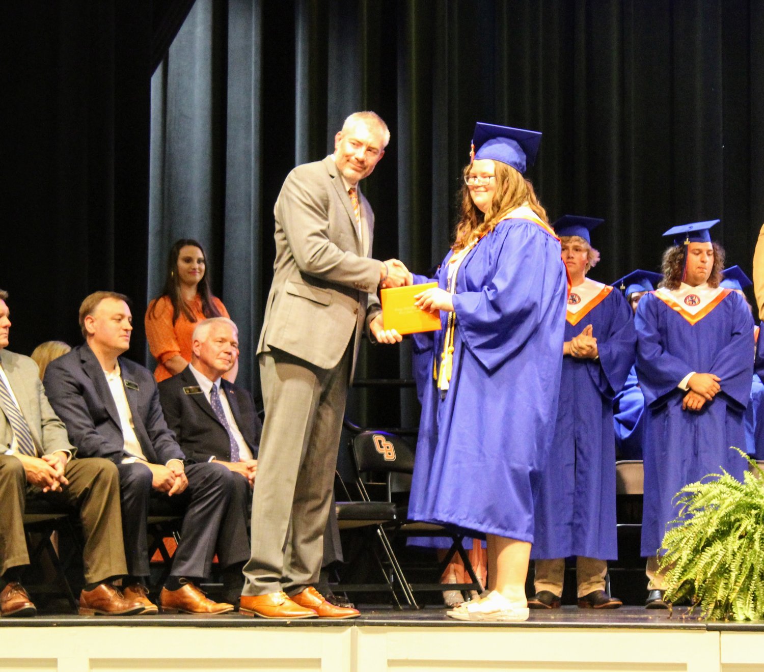 Miss Orange Beach High School, Kira Berona, excepts her diploma from Wes Pouncey, Orange Beach High School principal.
