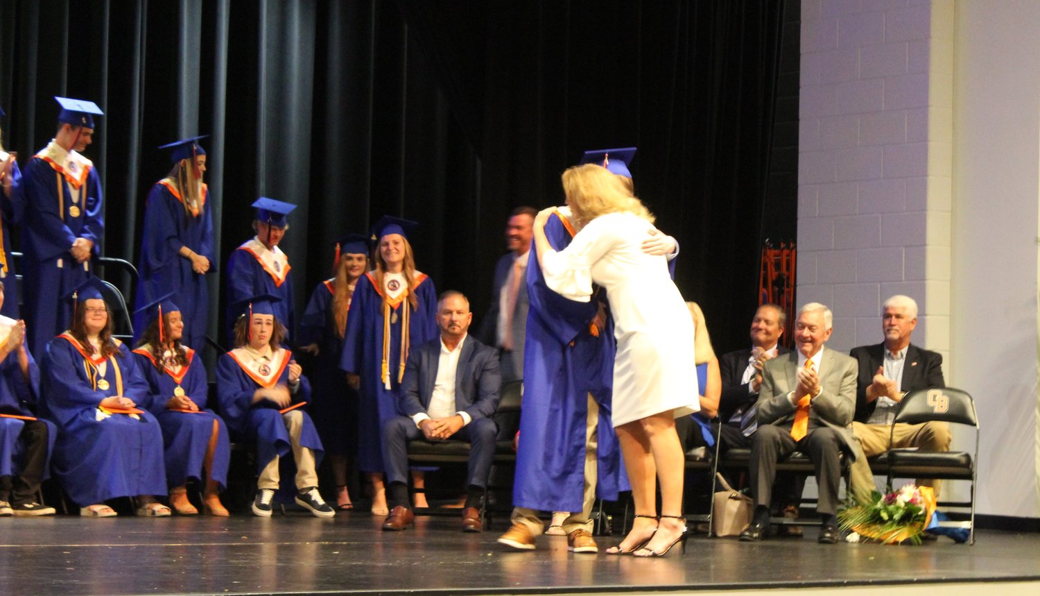 Former Orange Beach High School principal Robbie Smith shook every hand and hugged almost every neck before the students crossed to receive their diploma.