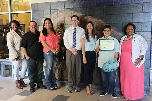 Foley Middle: Pictured here, from left: Assistant Principal Tiara Bailey, Shining Star student Pedro Silva’s parents, FOX 10 TV’s meteorologist Michael White, Baldwin EMC representative Kim Frank, Foley Middle School student Pedro Silva and teacher Annie Shoots.