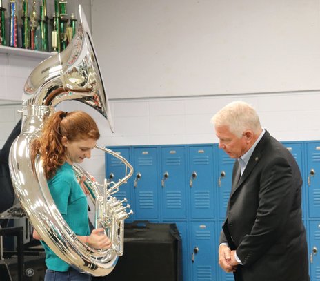 System Superintendent Eddie Tyler learns the mechanics of musical instruments from members of the RHS band.