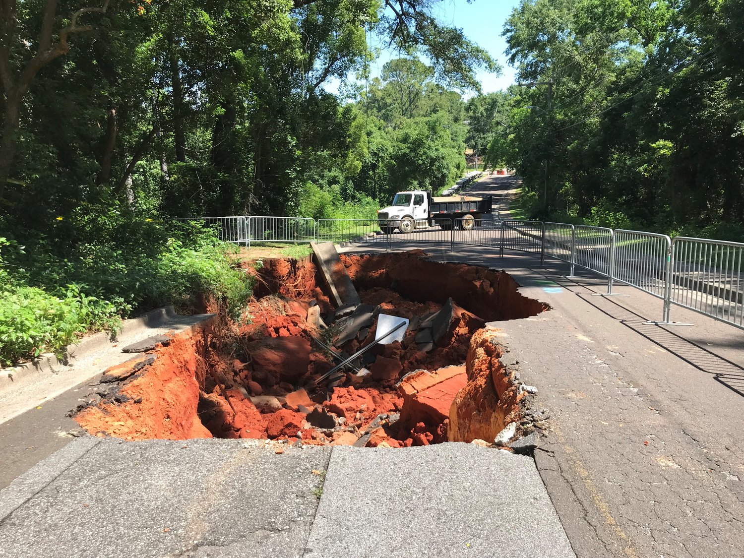 Portions of Bancroft Street collapsed Thursday morning when a sinkhole 85 feet long and 13 feet deep appeared on the street between the Eastern Shore Arts Center and Fairhope West Elementary School.