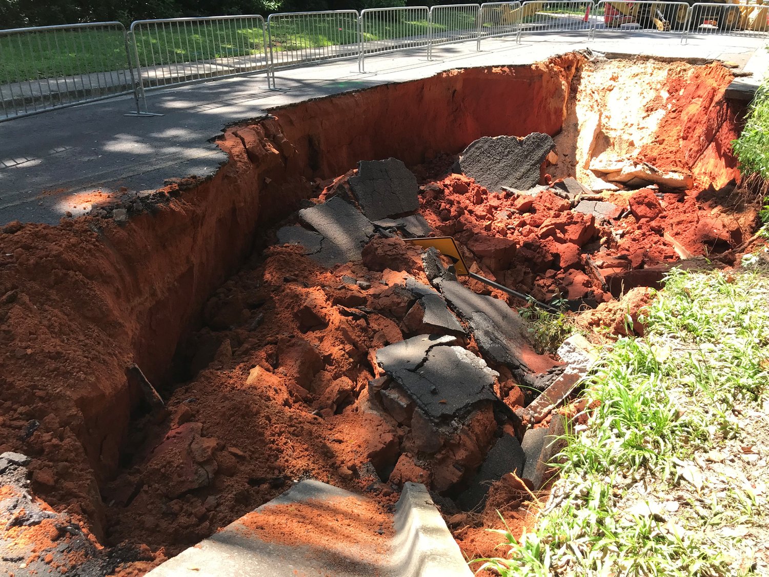 Portions of Bancroft Street collapsed Thursday morning when a sinkhole 85 feet long and 13 feet deep appeared on the street between the Eastern Shore Arts Center and Fairhope West Elementary School.