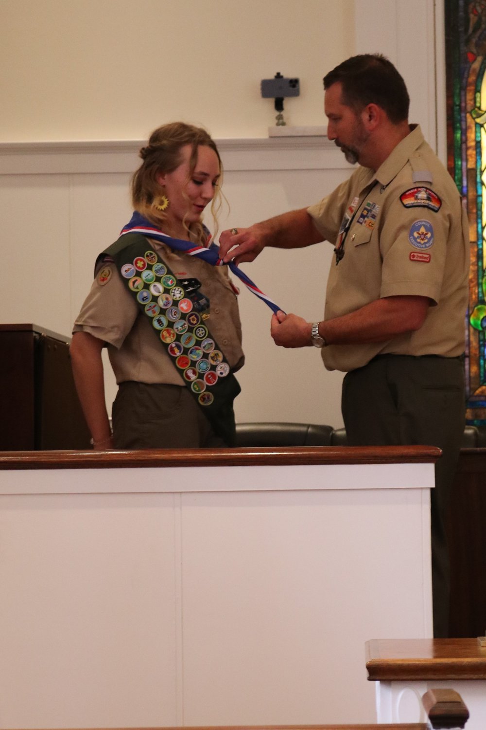 Dorothy Myers is presented her Eagle Scout neckerchief by her father, John. Dorothy is the fifth Eagle Scout in the Myers family.