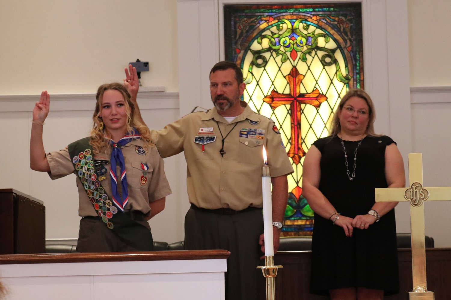 New Eagle Scout Dorothy Myers and her father John recite the Eagle Scout Charge, along with the other Eagle Scouts attending the Court of Honor ceremony.