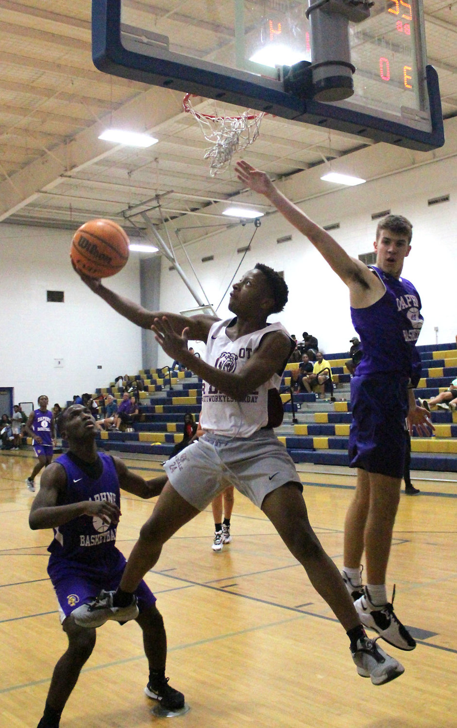 Robertsdale’s Ja’Leal White goes up for a reverse layup through traffic in the second half of the Golden Bears’ summer league game against the Daphne Trojans last Thursday, June 9, at Fairhope High School.