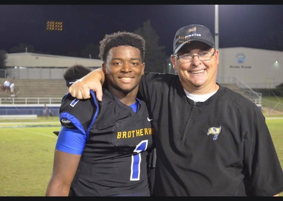 Fairhope Pirate Head Football Coach Tim Carter poses for a picture with 2018 graduate CJ Edwards after a game on W.C. Majors Field at Fairhope Municipal Stadium. Edwards was laid to rest Friday.
