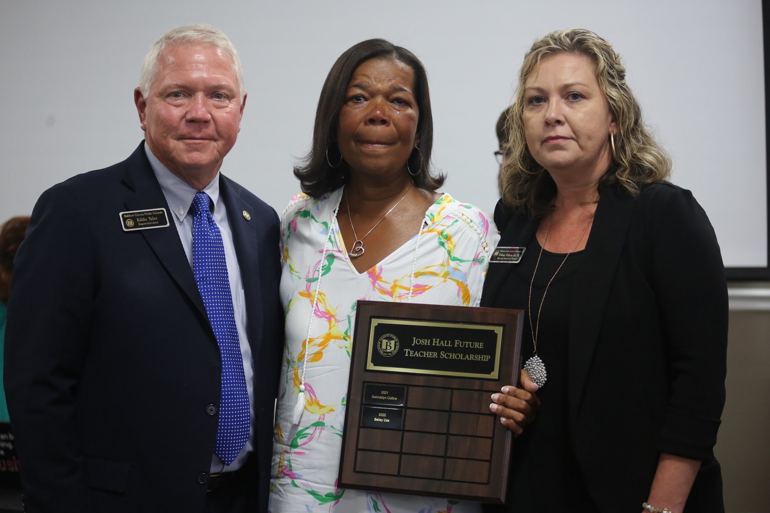 Angie Hall, center, principal at Fairhope Middle School, is presented a plaque in honor of her son Josh by BCBE Superintendent Eddie Tyler and BCBE HR Director Tiffany Wilson. The plaque will be placed in Fairhope Middle School. Each year, the names of the recipients of the Josh Hall Memorial Scholarship will be added.