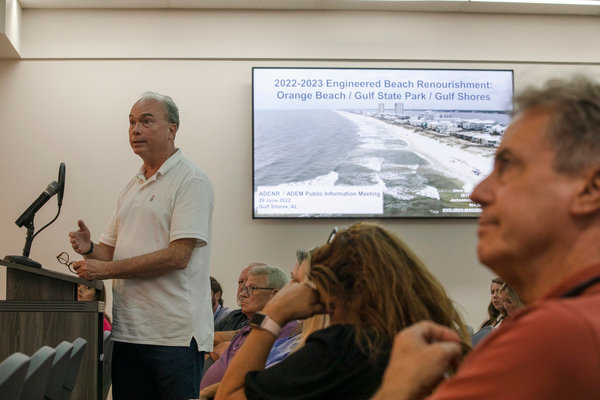 Orange Beach resident George Neville speaks during the public comment portion of an information session about the upcoming beach renourishment project.