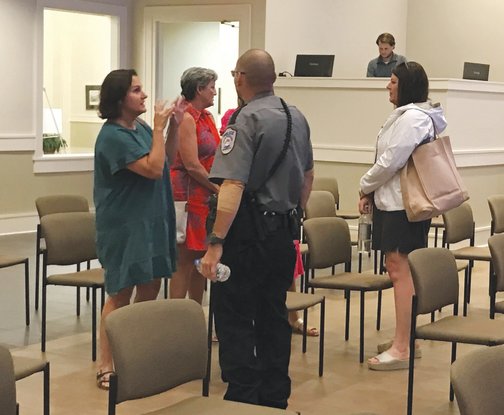 Residents talk to Spanish Fort police school resource officers during a public meeting on school safety held Tuesday, June 28, at Spanish Fort City Hall.
