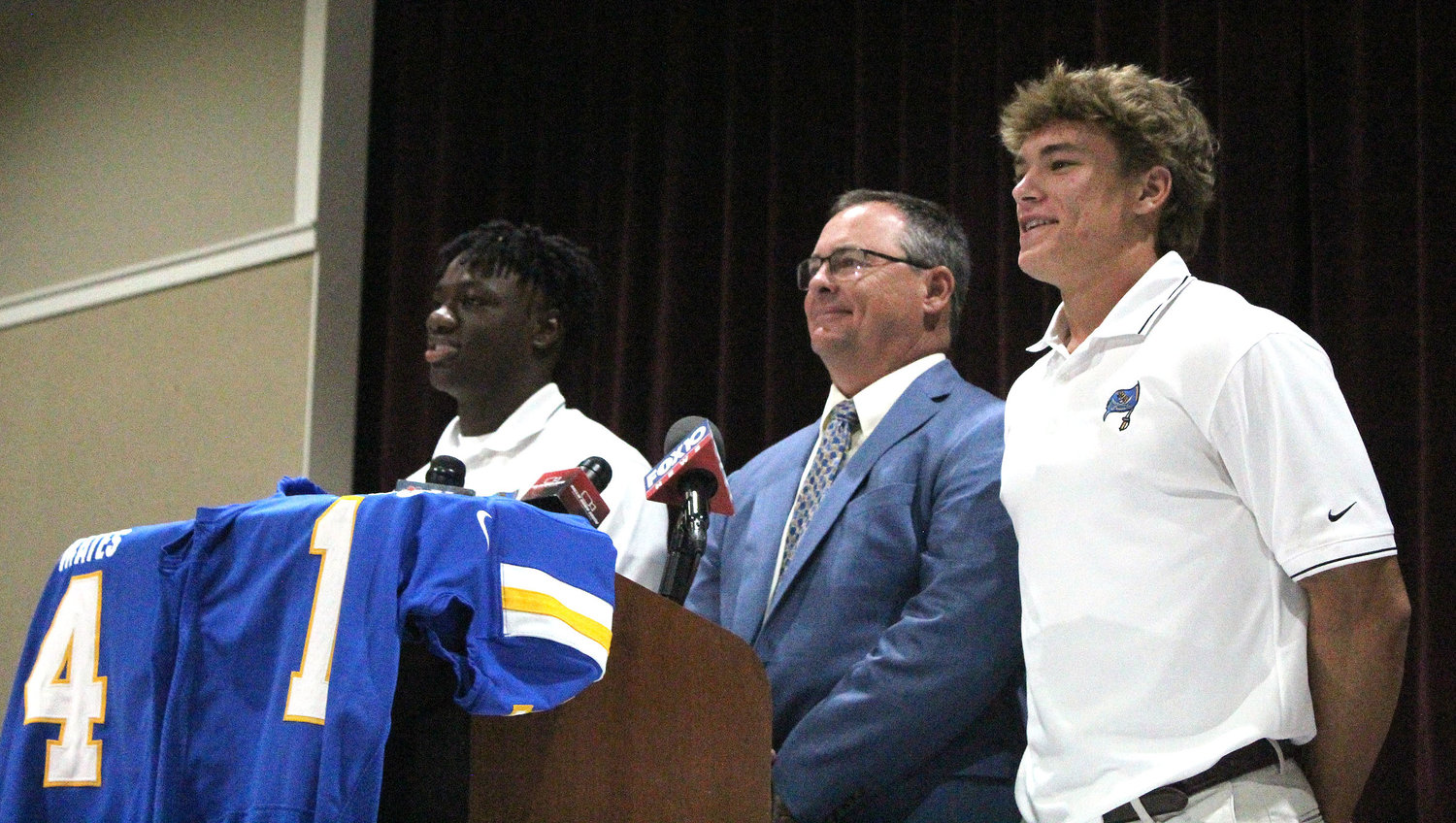 Fairhope's Qualin McCants, coach Tim Carter and Caden Creel kicked off the 2022 Baldwin County Media Day event at Daphne High School last Wendesday, July 13.