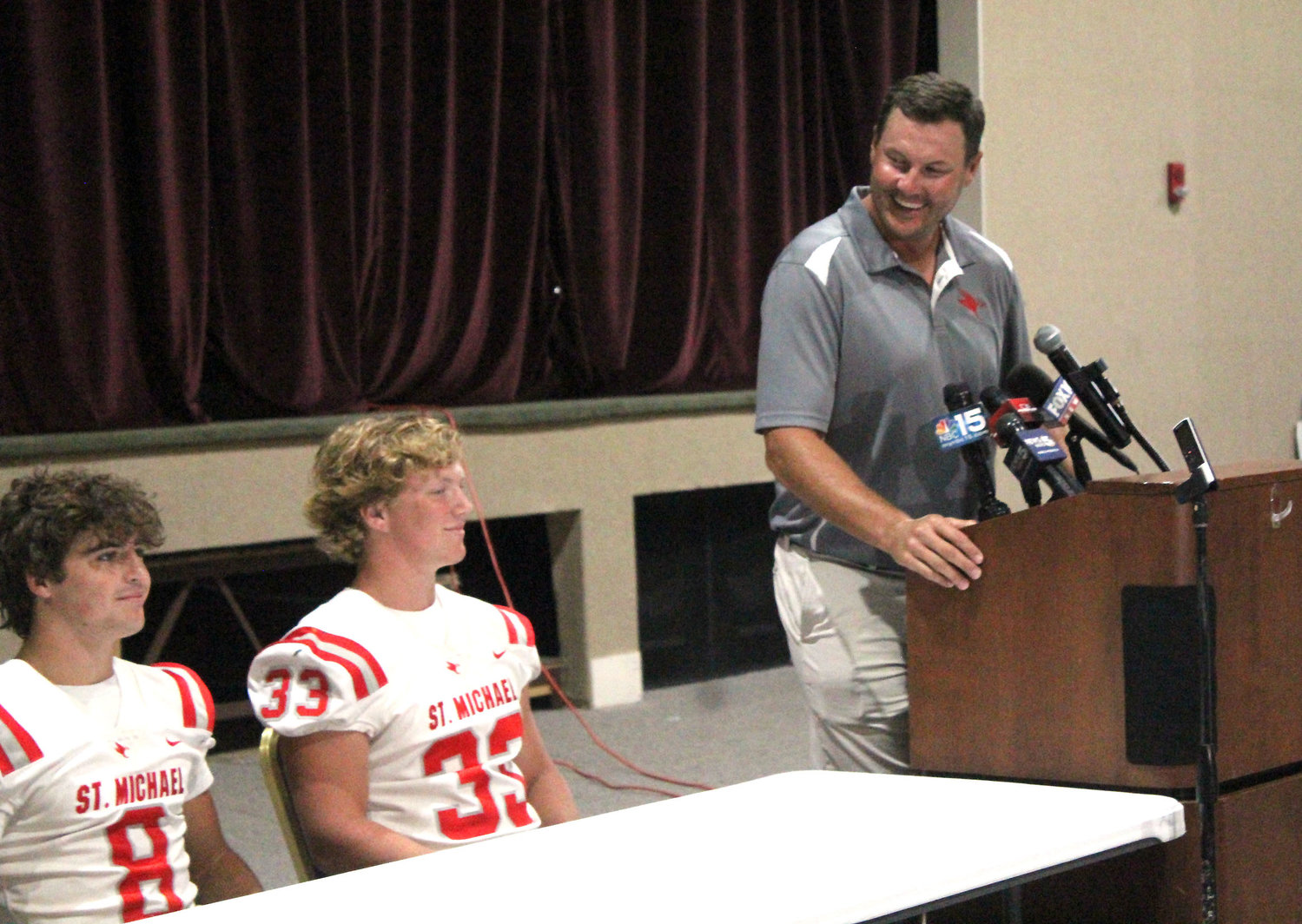 St. Michael Catholic Head Coach Philip Rivers was joined by senior Cardinals Ezra Sexton (8) and Clay Barr (33) at last Wednesday's Baldwin County Media Day at Daphne High School.