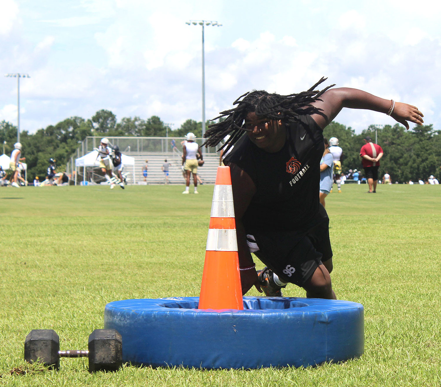 Baldwin County senior KeVontae Mason bends around a bag in the obstacle course during the Jubilee City Big Man Tournament in Daphne Thursday, July 14.