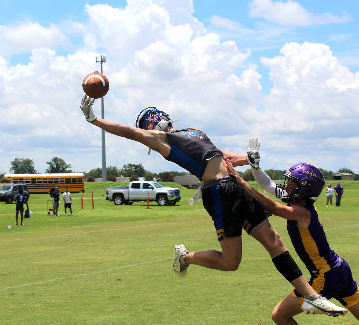 Fairhope senior Ben Moseley reaches out to try and haul in a pass attempt from Caden Creel during the Pirates’ pool-play game against the host Daphne Trojans at the Jubilee City 7-on-7 Tournament at the Al Trione Sports Complex Thursday, July 14.