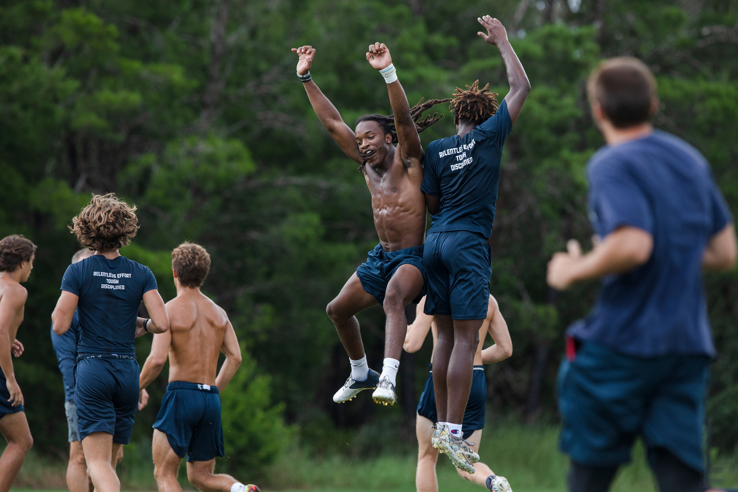 Dolphin junior Ronnie Royal celebrates with his teammates after a drill at Gulf Shores’ summer practice at the high school July 20.