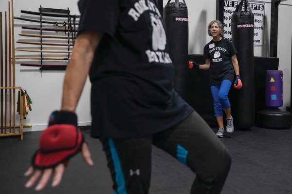 Instructor Jerry Marie Brown (foreground) demonstrates a balancing exercise during the public workout at Wheeles Karate Academy to celebrate Rock Steady Boxing – Gulf Shores' fifth anniversary July 27.