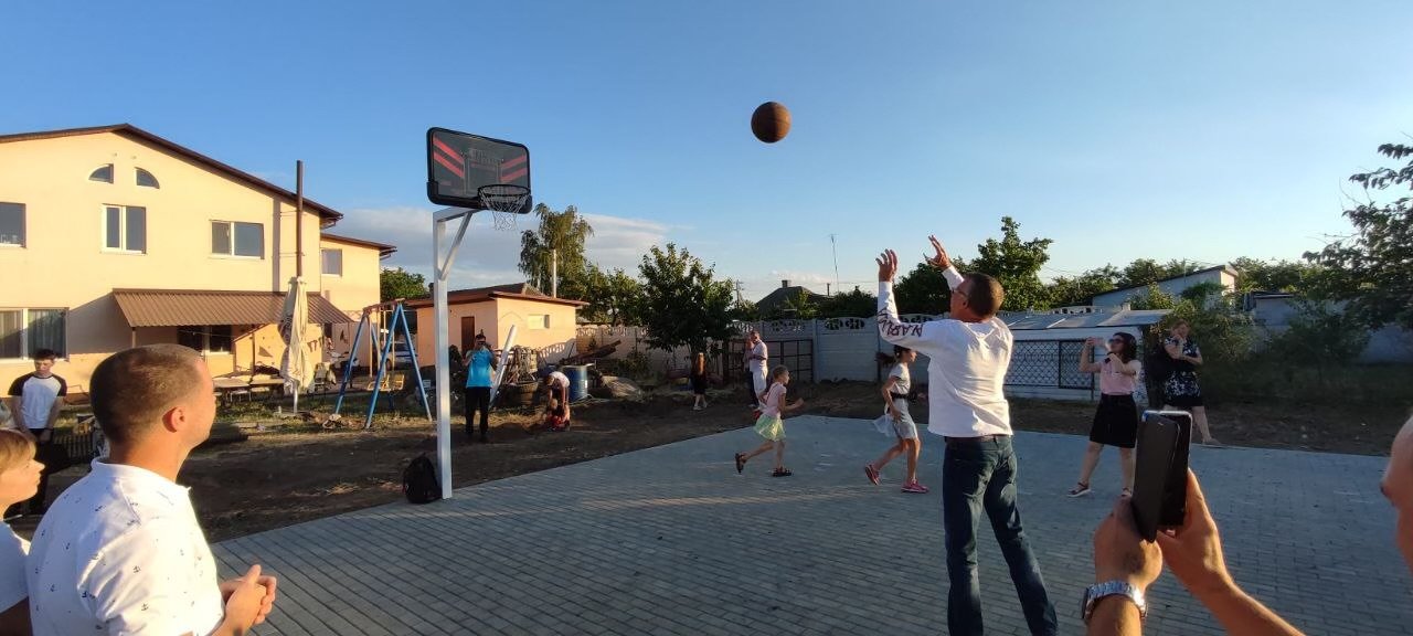 Members of the Bilhorod-Dnistrovskyi community in Ukraine play basketball on a court funded by a local congregant.