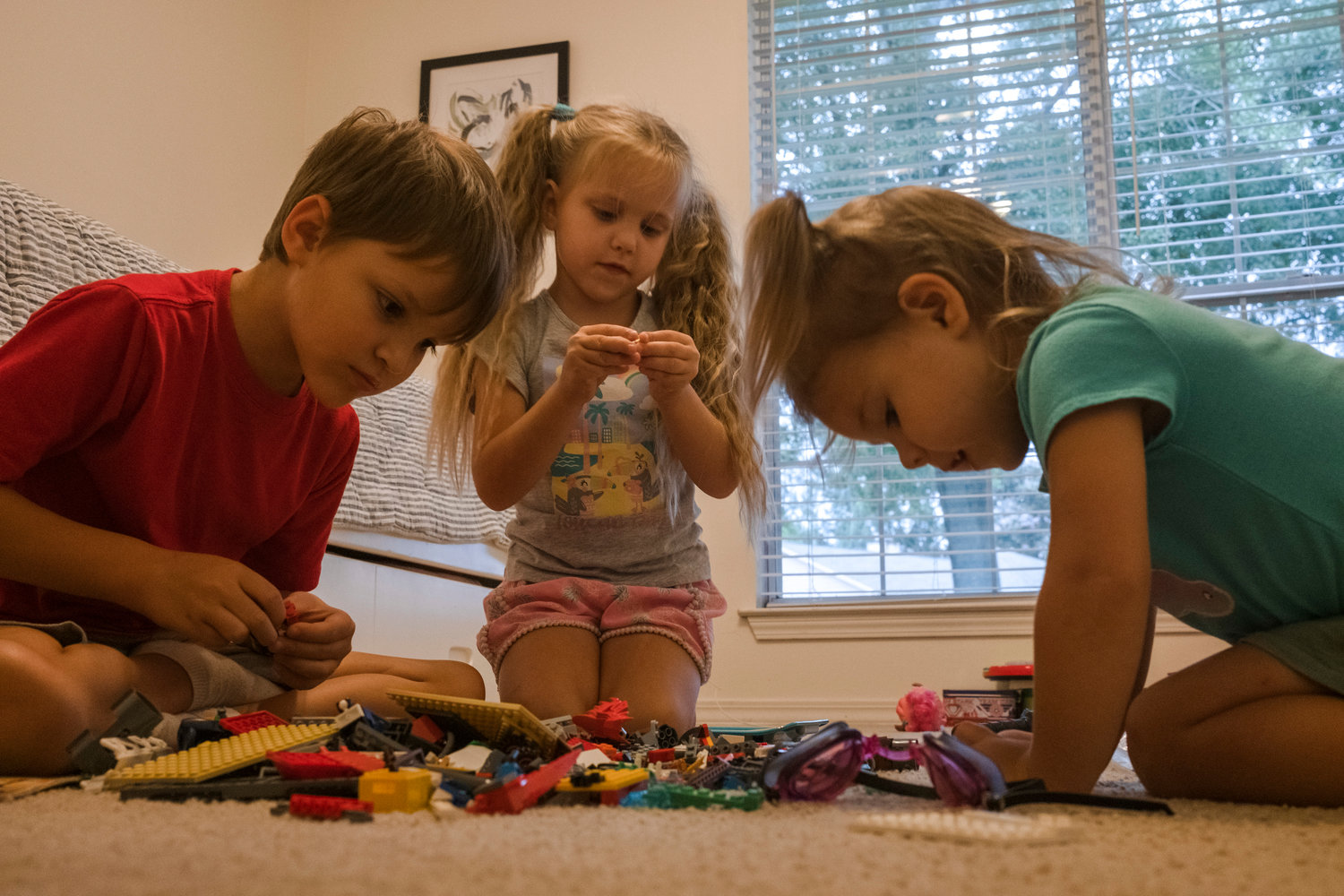 Victoria, 3, Masha, 6, and Oleg, 8 play in their temporary home in Robertsdale in July.