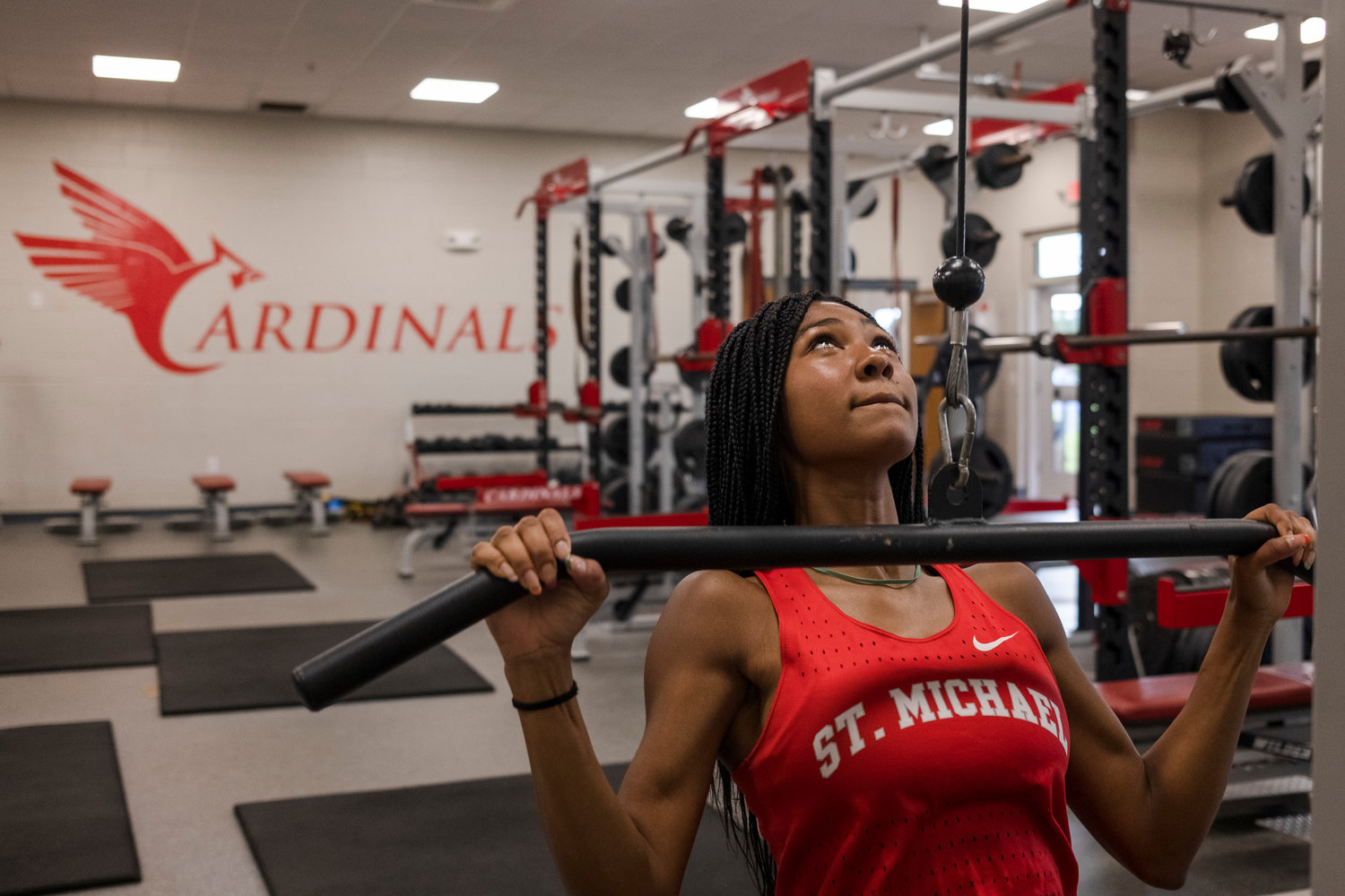 Cardinal senior Tia Acker works out in the St. Michael Catholic High School weight room Aug. 5. She was just a few weeks away from jogging again after she tore her ACL earlier this summer.