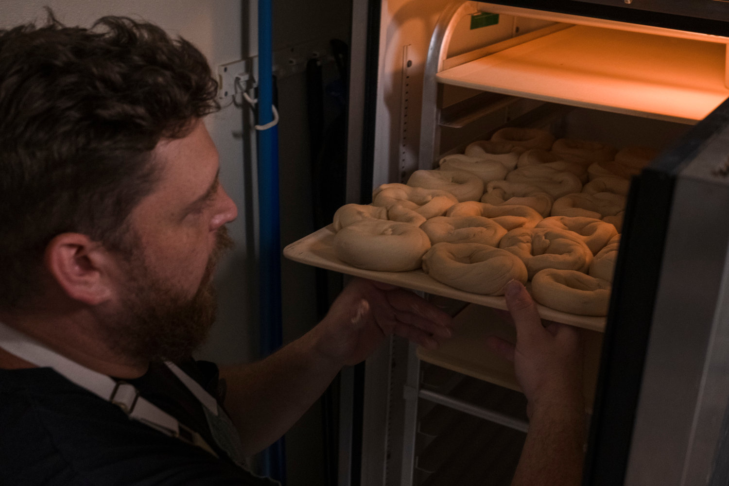 The dough circles go into a proofing box to slowly rise for 24 hours before they take a bath in a hot water solution that gives them the hard shell and the soft, chewy inside.