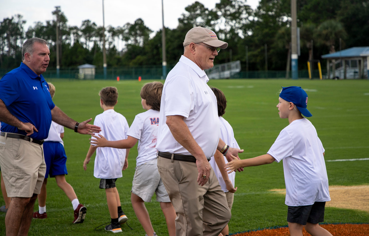 Orange Beach City School Board President Robert Stuart and Superintendent Randy Wilkes greet middle school football players as they were introduced to the community at last Friday’s Meet the Makos event at the Sportsplex.