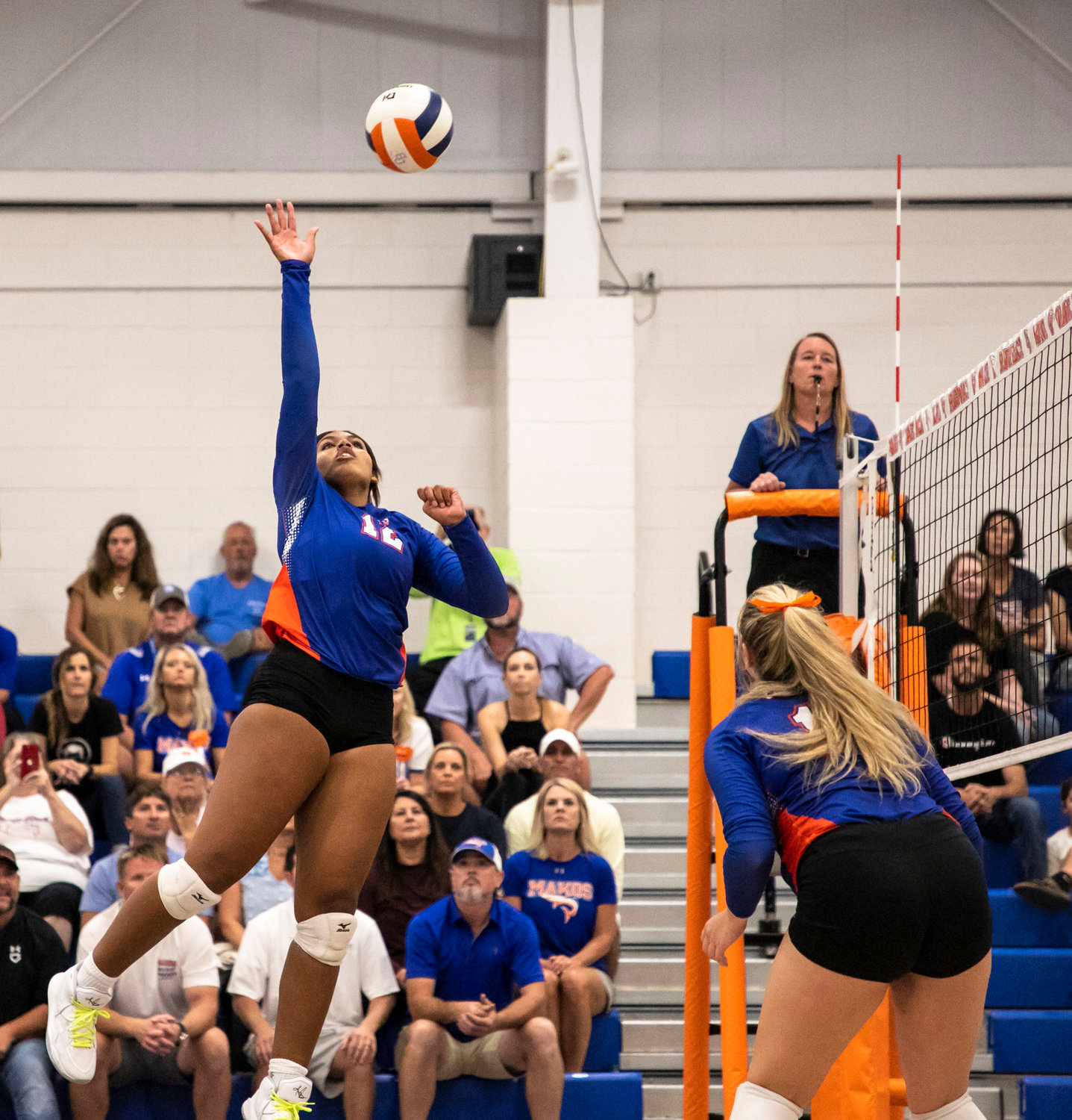 Orange Beach sophomore middle hitter Addie Roach soars for a spike during the Makos' home tri-match against the Gulf Shores Dolphins Thursday, Aug. 25. Orange Beach extended its winning streak to open the season after it won its host tournament, the Battle at the Beach, last weekend.