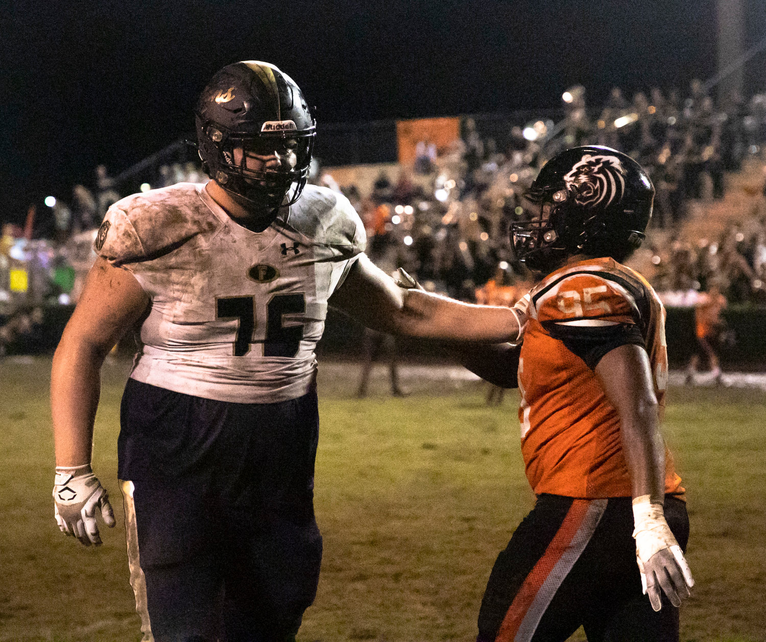 Linemen Logan Joellenbeck (76) and Kareem Stevens (95) acknowledge each other after Friday night’s non-region contest between the Foley Lions and Baldwin County Tigers in Bay Minette Aug. 26.
