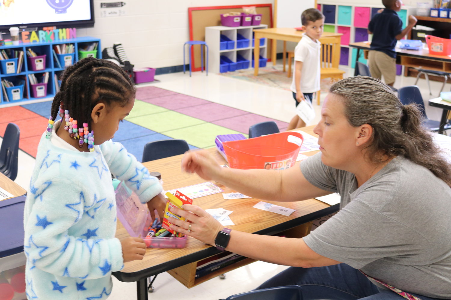 Part-time aides and behavior coaches join teachers in classrooms, assisting with younger children adjusting to the return to school.