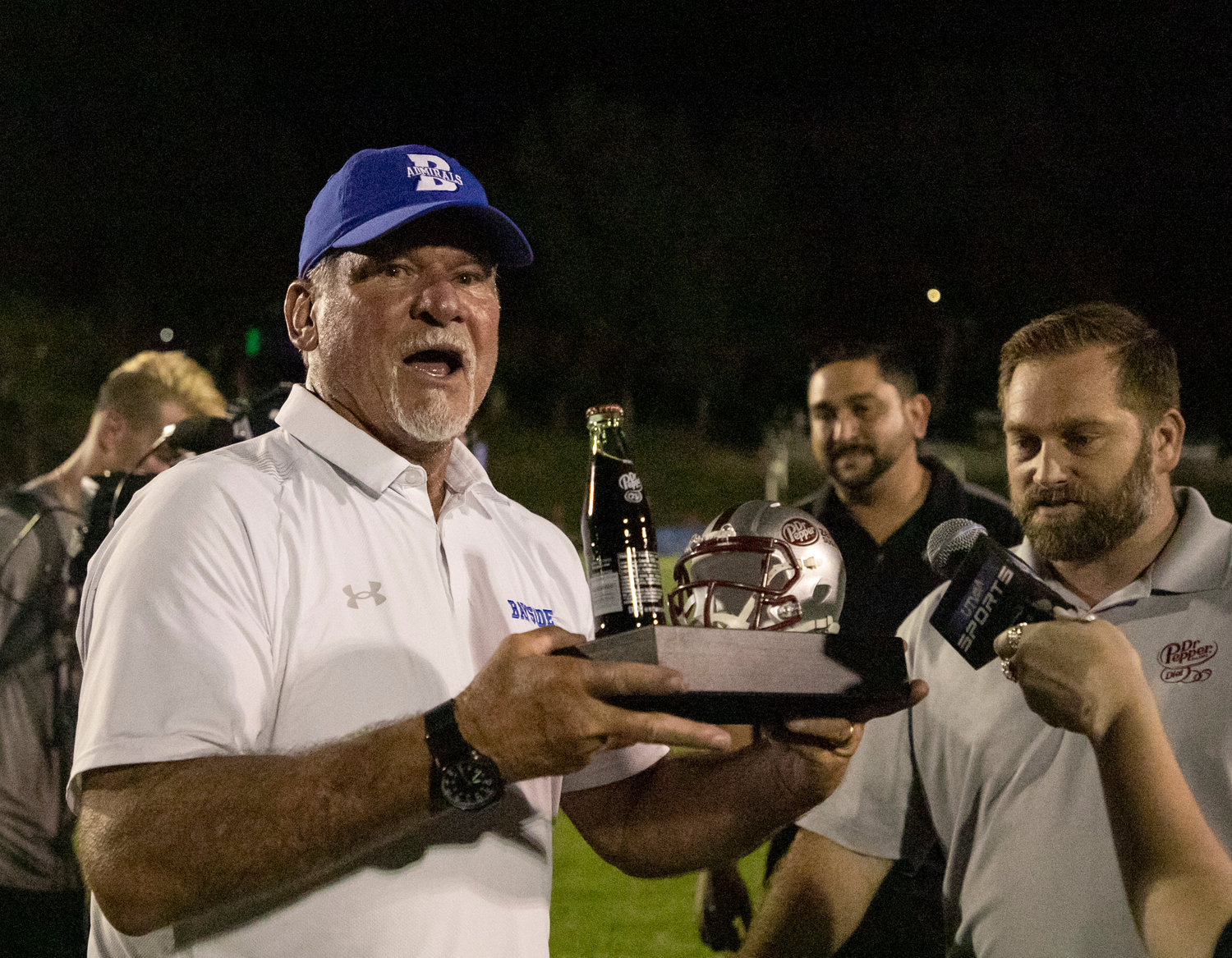 Bayside Academy head coach Phil Lazenby hoists the Dr. Pepper trophy the Admirals received for taking down St. Michael Catholic 17-14 to open region play Sept. 2 on Freedom Field in Daphne. Bayside Academy’s win last Friday secured Lazenby’s 200th for his career.