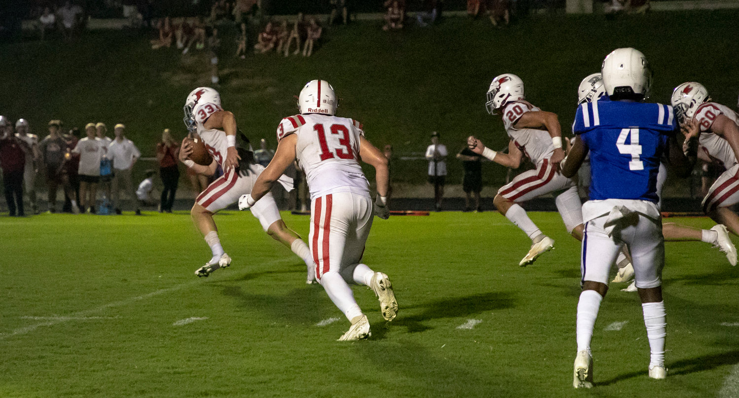 St. Michael Catholic senior Clay Barr (33) picked up a fumbled handoff and ran the 97 yards he needed to tie the game for the Cardinals in their region-opening game against Bayside Academy on the road Friday night.