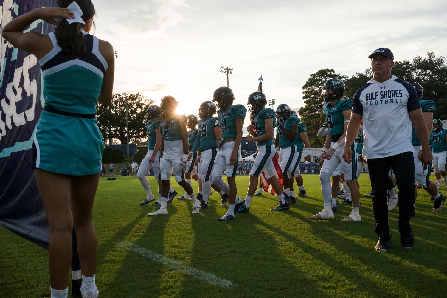 The Gulf Shores Dolphins prepare to take the field ahead of their season-opening game against the St. Michael Catholic Cardinals Aug. 18 in Fairhope. After a 22-12 win over Faith Academy to open region play last Friday night, head coach Mark Hudsepth has Gulf Shores out to the school's first 3-0 start to a regular season.