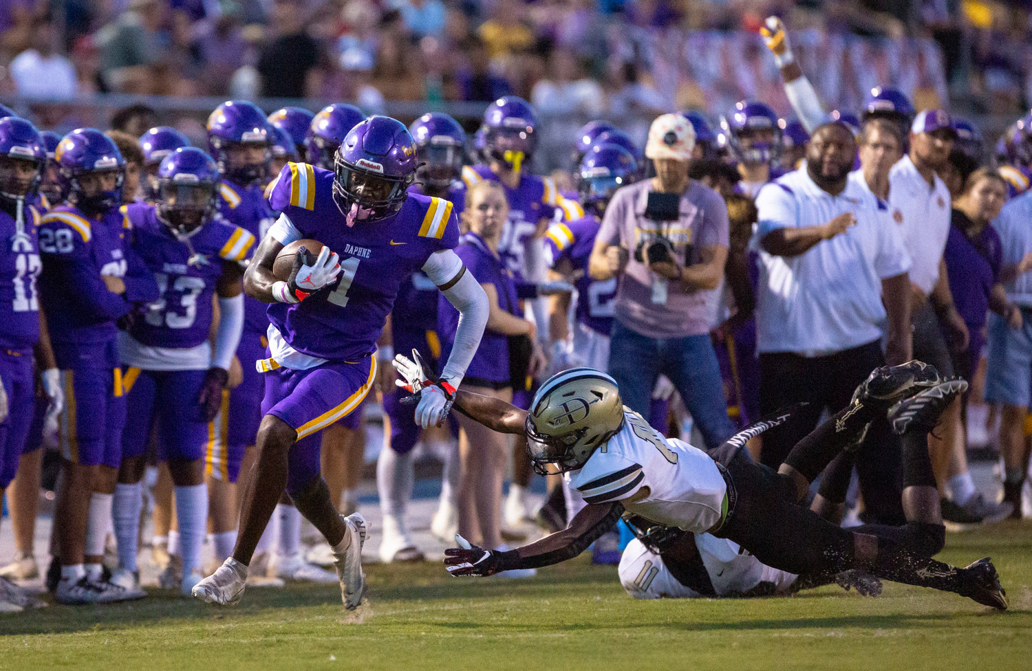 Daphne senior receiver Stacey Boykins outruns Davidson defenders on his 44-yard touchdown in the first half of the Trojans’ region game against the Warriors Friday night at Jubilee Stadium. Daphne won 40-21 to move to 2-0 in region play.