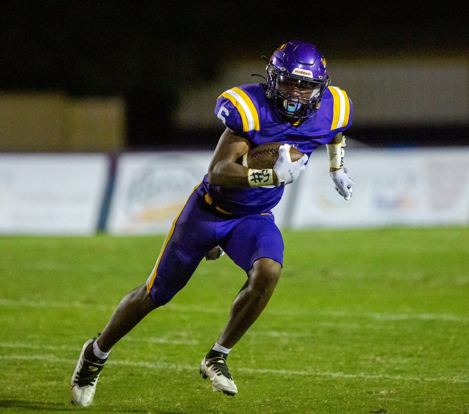 Daphne senior Stephon Blackshear hits the open field after he secured a catch in the first half of the Trojans’ region game against Davidson Friday night at home. Blackshear scored on a rushing touchdown in the second half to help Daphne win 40-21.