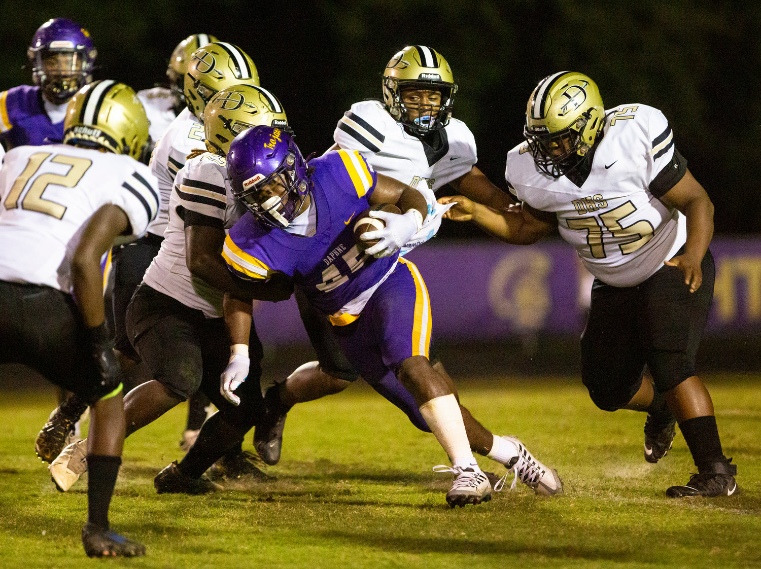 Trojan senior running back Nick Clark spins for more yardage on a first-half run during Daphne’s region game against Davidson at Jubilee Stadium Friday night. Clark opened the scoring with a three-yard touchdown run.