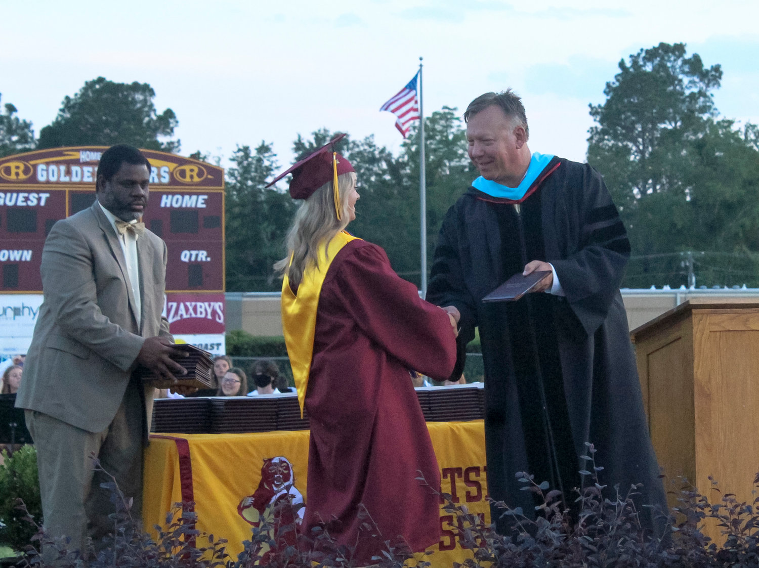 Robertsdale Principal Joe Sharp presents a diploma to 2022 SGA President Alison McDaniel during the 95th graduation ceremony May 16 at J.D. Sellars Stadium. Sharp was appointed as an assistant superintendent for Baldwin County Public Schools Friday, Sept. 16.