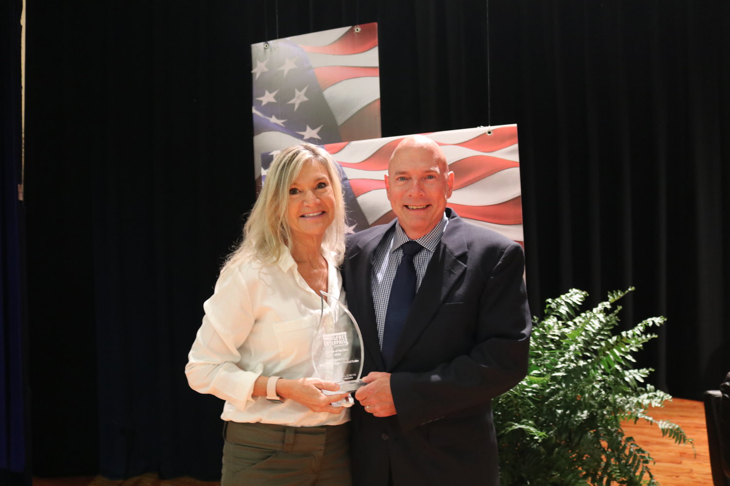 Margaret Roley, CEO of South Baldwin Regional Medical Center, receives the 2022 Walton M. Vines Free Enterprise Person of the Year award from last year’s recipient David Worthington, owner of Magnolia Springs Bed and Breakfast.