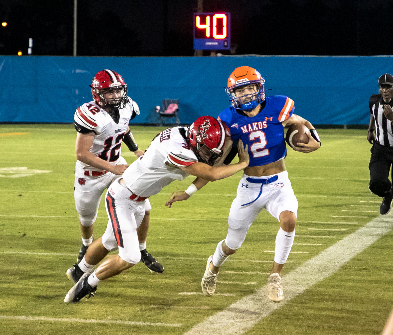 Orange Beach senior Cash Turner is pushed out of bounds by T.R. Miller senior Broox Hart during the region contest between the Makos and Tigers at the Orange Beach Sportsplex Friday, Sept. 16.