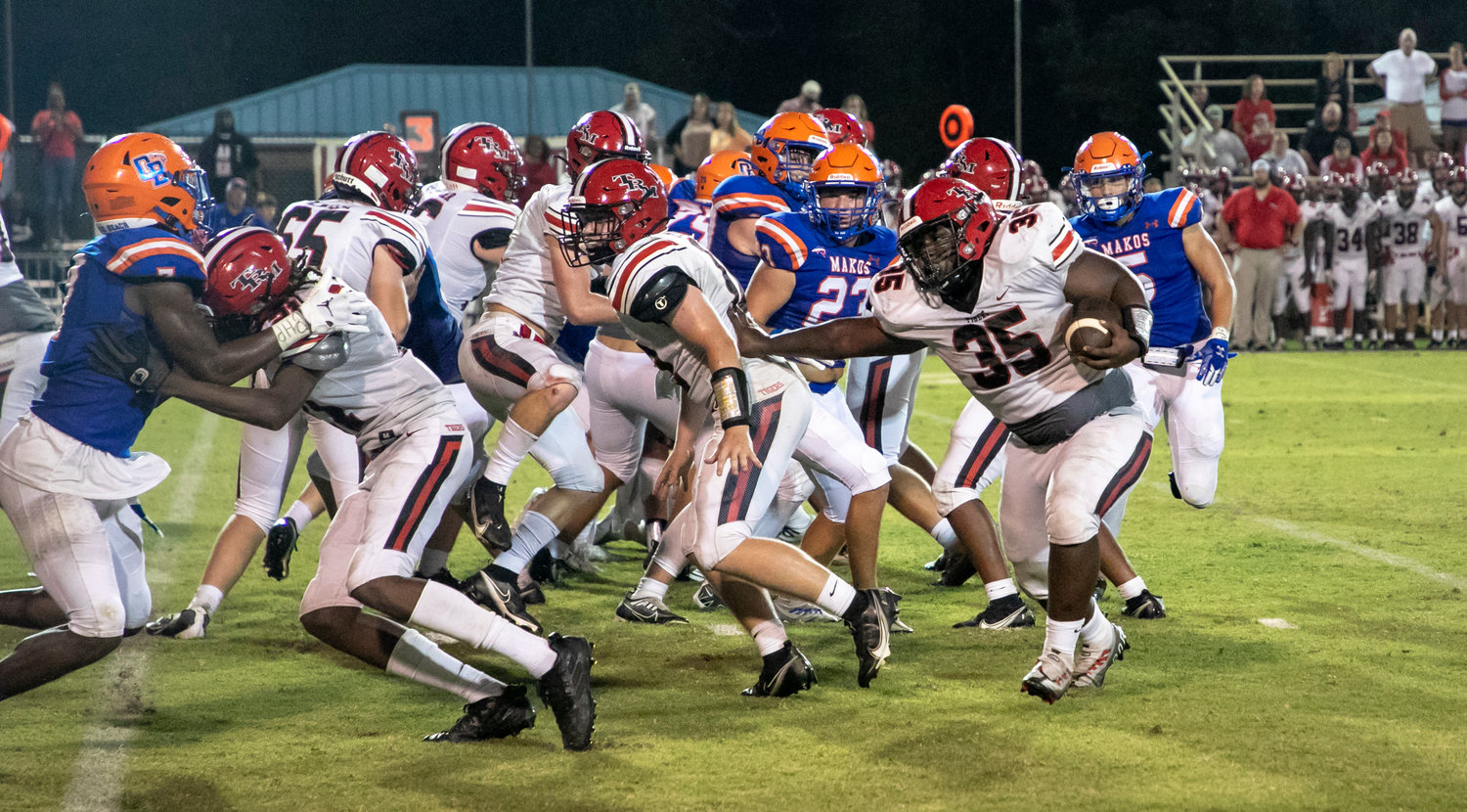 T.R. Miller senior Damorae Fountain looks for running room during the Tigers’ away game within Class 4A Region 1 against the Orange Beach Makos Friday night. Fountain helped lead the T.R. Miller run game with 16 carries on the night.