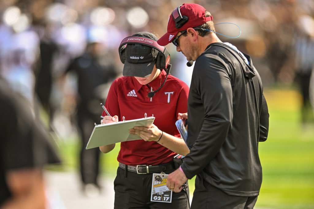 Troy student assistant and Baldwin County High School alumna McKenzie Bryant confers with Trojan defensive analyst David Mackie during the non-conference game against the Appalachian State Mountaineers Saturday, Sept. 17, in Boone, North Carolina.