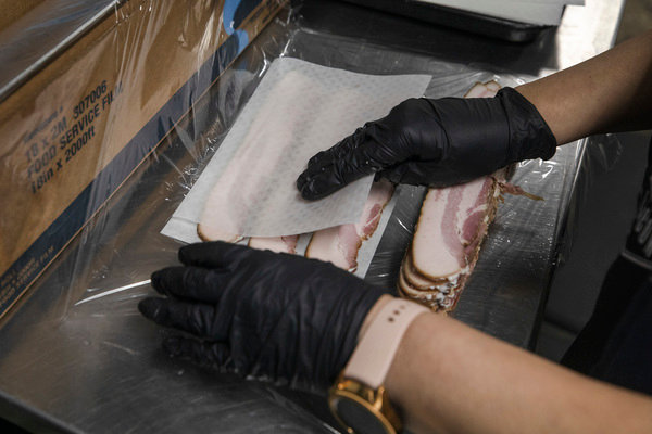 Stitt processes pork bellies by hand, in small batches.