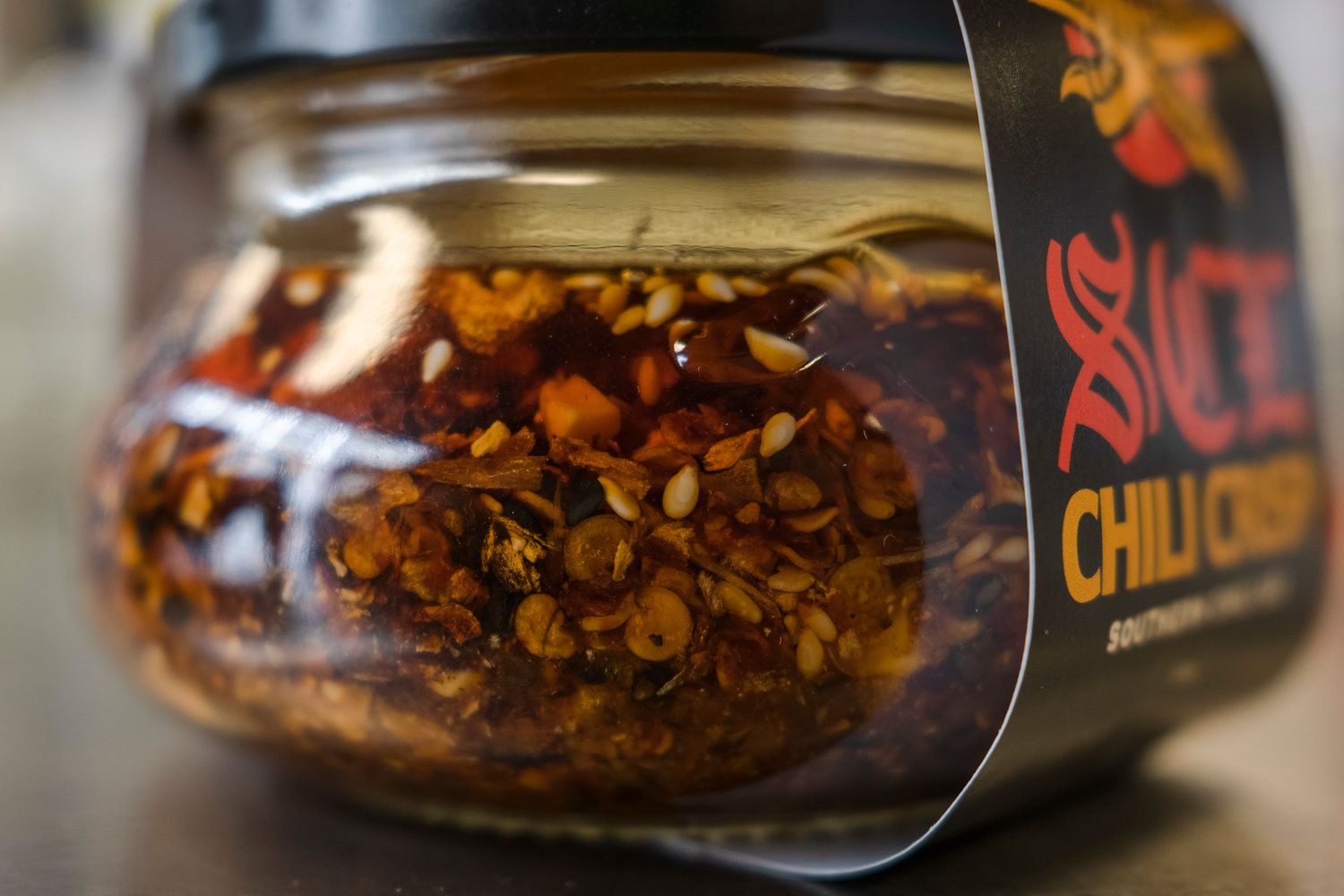 Chili crisp is a two-for-one condiment. The crisp adds flavor and texture to anything from soft cheese and scrambled eggs to dessert. The oil can be used for cooking or finishing a dish. The Southern Chili Lab's red chili crisp has a nice heat that will not ruin your palate.